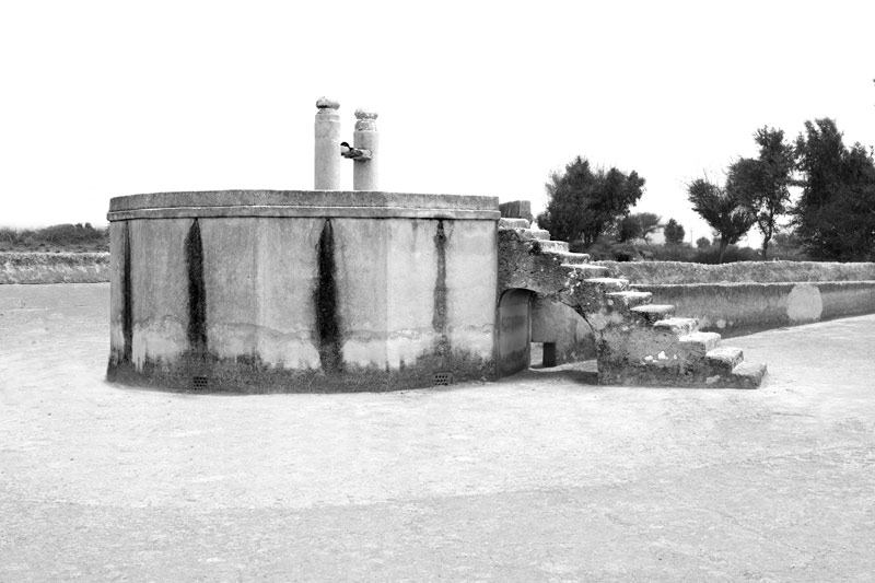 Traditional water supply science and technology of India - underground water storage tank ('kund') with its large catchment on the outskirts of a village in Thar Desert, Bikaner district, Rajasthan